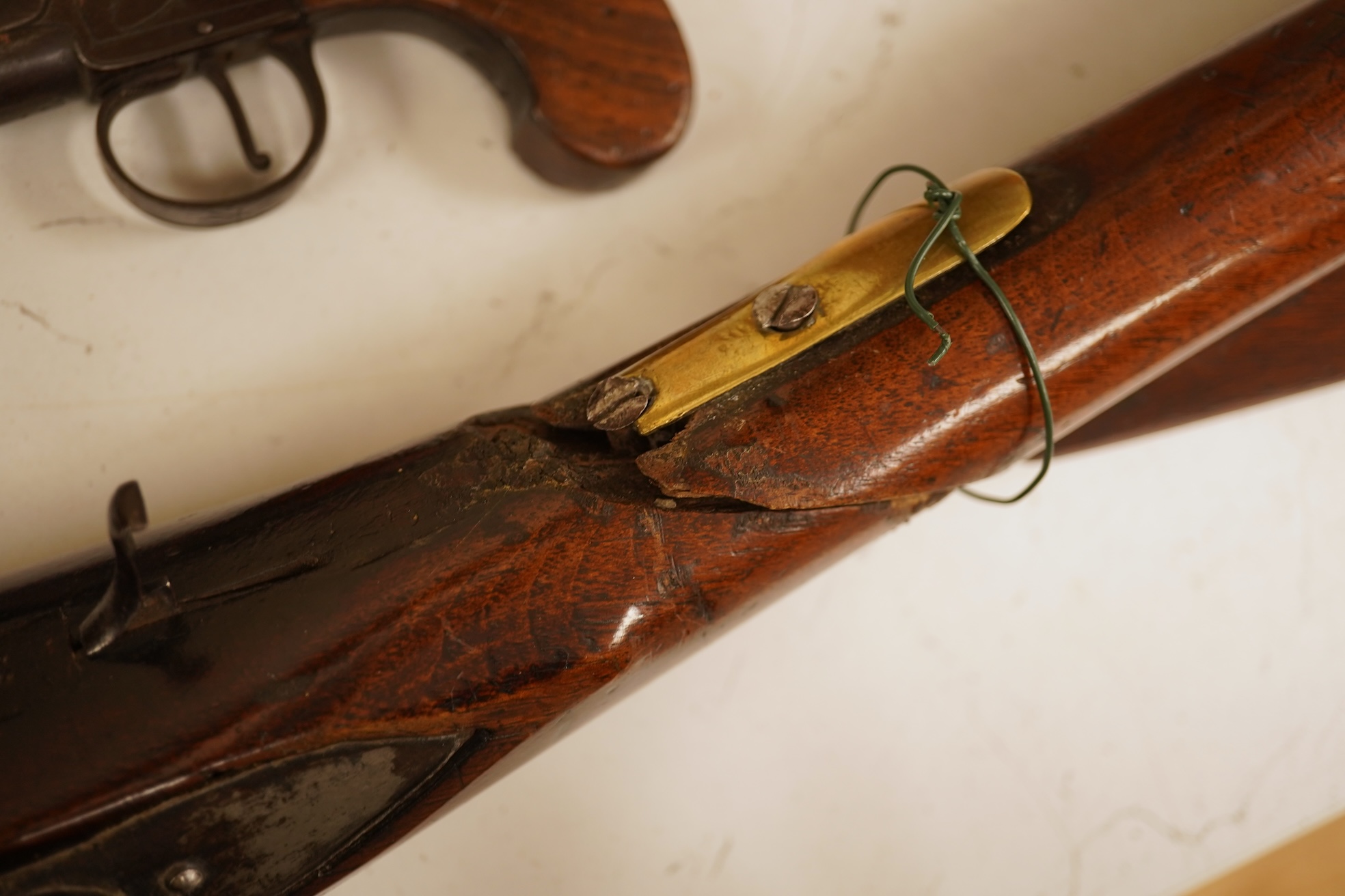 A pair of 19th century pocket pistols, shot flask and a brass musket, 81cm in length